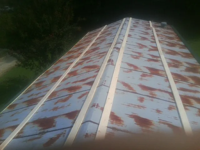 Rusted metal roof panels with new wood purlins before replacement — Storm Damage Roof Repair in Scio by Roofing Brothers